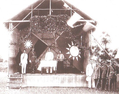 Szun Jat-szen (az emelvényen, az asztal mögött) és Csang Kaj-sek (az emelvényen, egyenruhában) 1924-ben egy Kuomintang-rendezvényen